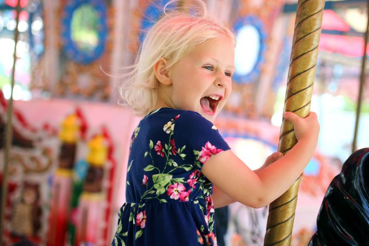 child on merry go round at a carnival