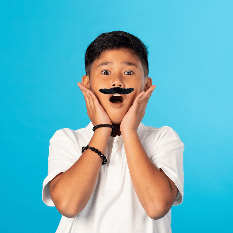 boy wearning falke mustache