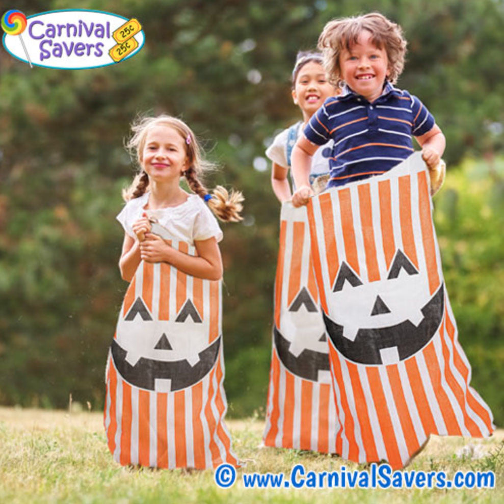 children jumping in a falll pumpkin sacks