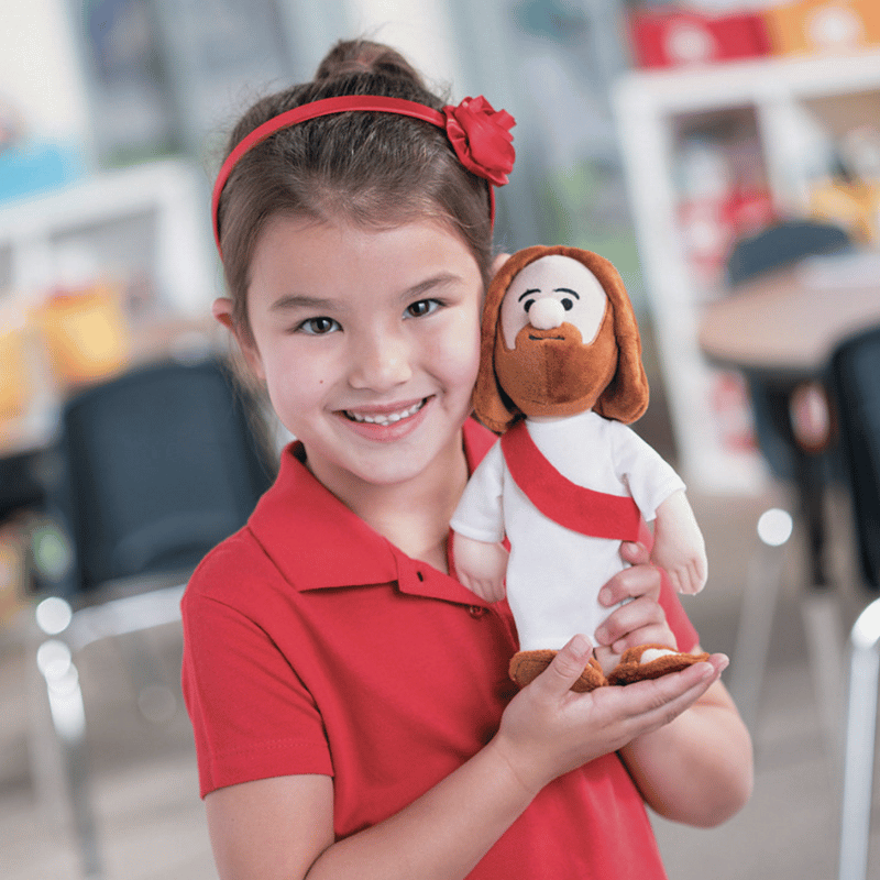 girl holding jesus doll